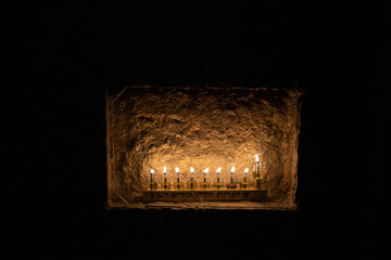 Oil lights from a Hanukkah menorah inset into the wall of a home in Jerusalem during the...
