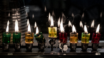 Multi-colored glass vials hold oil and wicks to light the Hanukkah menorah during the celebration of the Festival of Lights in Israel.