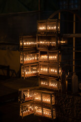Glowing Hanukkah menorahs lit with small vials of oil burn in protective glass housing outside an apartment building in Jerusalem during the Festival of Lights in Israel