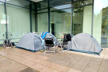 Homeless tents with things on the street. Homeless people. The problem of big cities, the concept...