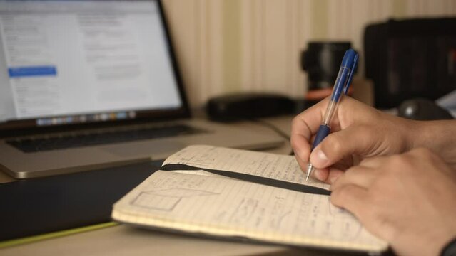 Man makes working entry in his diary