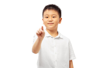 Kid looking at finger pressing and pointing, wearing white shirt