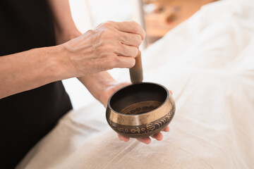 Fototapeta na wymiar Healing and sounds therapy with tibetan bowl