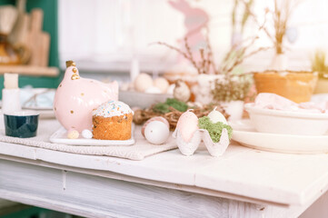 happy easter and spring holidays time. festive tablescape set decor. traditional dinner food easter eggs and baked cakes on table at home. rabbit and willow. pale pop pastel blue and pink color. flare