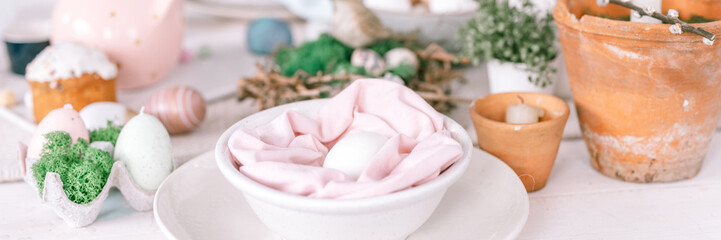 happy easter and spring holidays time. festive tablescape set decor. traditional dinner easter eggs and baked cakes on table at home. rabbit and willow. pale pop pastel blue pink color. banner. flare