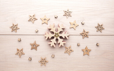 Christmas background with wooden stars and snowflake on a wooden plank