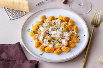 Pumpkin gnocchi with Parmesan cheese and herbs. Healthy eating. Vegetarian food.