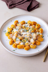 Pumpkin gnocchi with Parmesan cheese and herbs. Healthy eating. Vegetarian food.