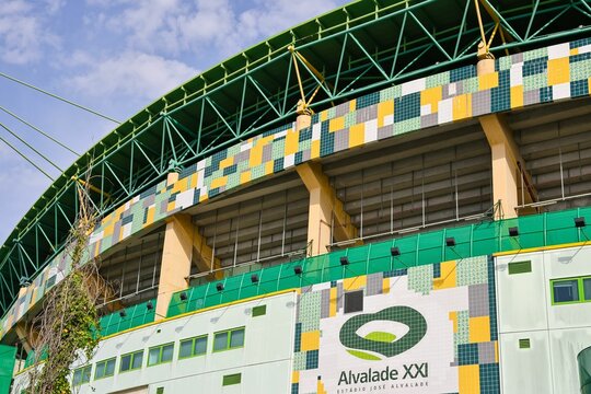 Low-angle partial view of Jose Alvalade Stadium exterior under the blue sky in Lisbon