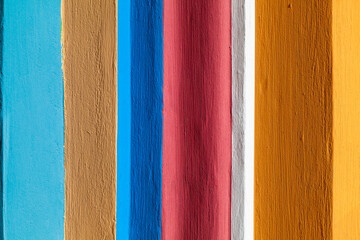 Colorful painted vertical stripes on uneven surface background