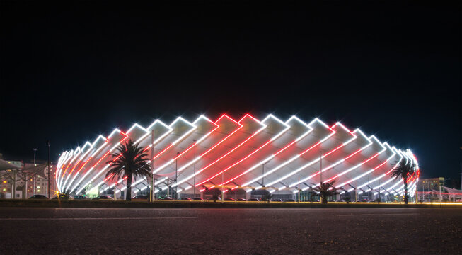 Batumi, Georgia, October, 27, 2021: Batumi Stadium, Night view of the illuminated modern stadium building in a white and red colors