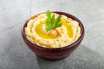 Chickpeas hummus with olive oil in the bowl.