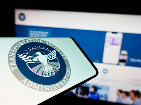 Stuttgart, Germany - 10-24-2022: Mobile phone with seal of Transportation Security Administration (TSA) on screen in front of website. Focus on center-right of phone display.