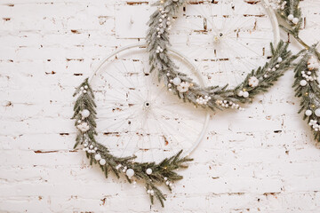 Christmas, New Year composition. Festive wreathes with white balls made of Xmas tree, fir branches...