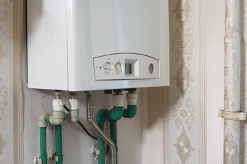 new modern white gas boiler on the wall