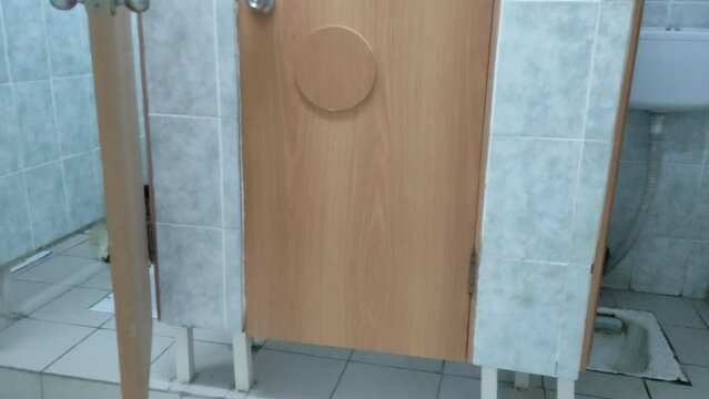 Public toilet with a cubicles, urinals and tiles