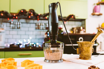 Home kitchen decorated with garland lights, preparing christmas cookies