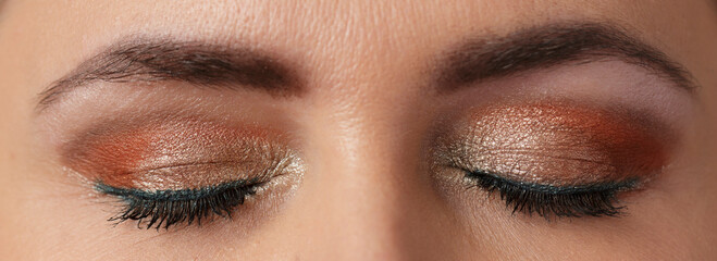 Naklejka premium Evening make-up on women's closed eyes, close-up, macro