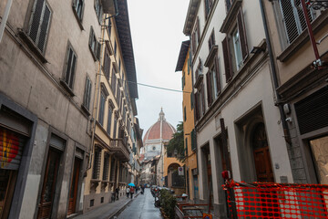 Narrow European cozy street on a rainy day in Florence, Italy