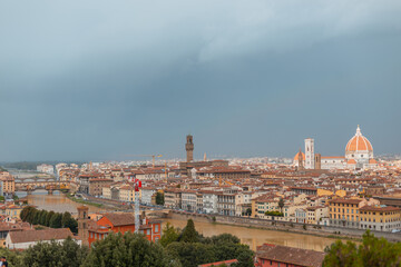 Fototapeta na wymiar Amazing beautiful city of Florence, Italy with ancient buildings and cathedrals with river and bridge on a cloudy day