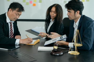 Lawyers discuss agreements with clients or staff at the office.