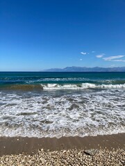 stormy sea in Acharavi, small resrt in Corfu island, Greece with Albania mountains in a distance