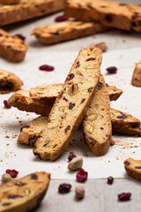 Biscotti cookies stacked vertically made with cranberry and pistachio nuts. Biscotti or cantucci are traditional italian baked sweet biscuits, popular during winter holidays as a snack or dessert