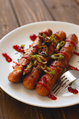 Grilled sausages with green peppers and ketchup