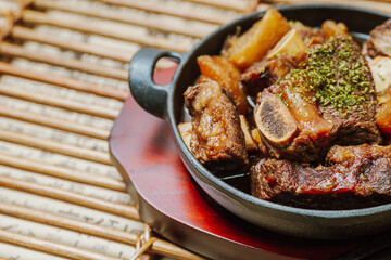 galbijjim, Korean Braised Short Ribs : Beef short ribs, trimmed of fat, seasoned in sweet soy sauce, and braised until tender with carrots, chestnuts, ginko nuts, and other vegetables.