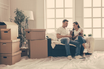 close up. cute young couple discussing something sitting on the sofa.