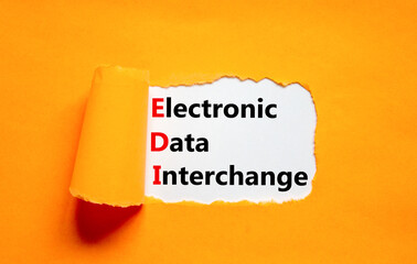 EDI electronic data interchange symbol. Concept words EDI electronic data interchange on white paper on a beautiful orange background. Business and EDI electronic data interchange concept. Copy space.