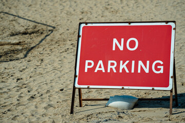 A no parking sign on the beach