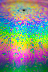 Photo of iridescent surface of soapy water. Space, halographic, psychedelic background for screensaver.