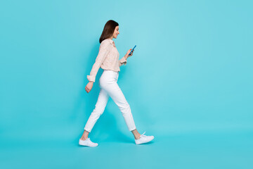Fototapeta na wymiar Full length photo of charming lady trendy clothes use twitter facebook texting comment blog empty space isolated on cyan color background