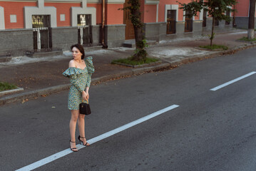 Young woman walking in summer city