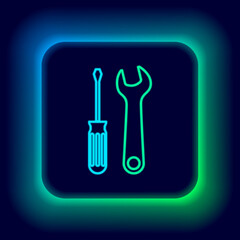 Glowing neon line Screwdriver and wrench tools icon isolated on black background. Service tool symbol. Colorful outline concept. Vector