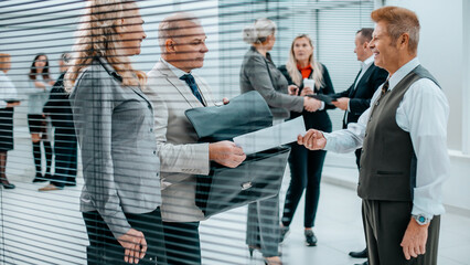 Fototapeta premium close up. successful businessman handing document to his business partner.