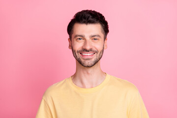 Portrait of positive satisfied handsome man with stylish haircut wear yellow t-shirt smiling at camera isolated on pink color background