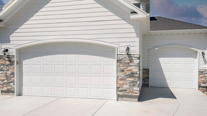 Panorama Puffy clouds at sunset Three car garage exterior with two white garage doors with arche - obrazy, fototapety, plakaty