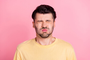 Portrait of stressed strained handsome man stylish haircut yellow t-shirt holding breath eyes...