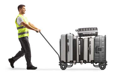 Airport worker pushing a luggage cart with suitcases