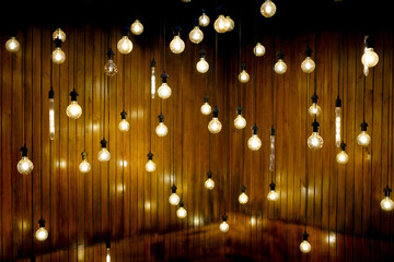 Lots of rustic light bulbs in front of wooden background