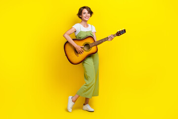 Full body photo of lovely young lady holding playing acoustic guitar dressed stylish khaki garment...