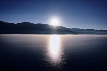 Sunrise over the mountain with reflection on the lake