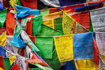 Tibetan Buddhism prayer flags (lungta) with prayer mantra Om mani padme hum in tibetan language. Leh, Ladakh, Jammu and Kashmir, India - obrazy, fototapety, plakaty