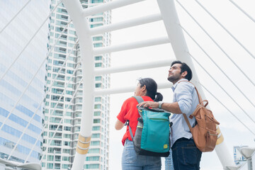 Travelers couple look at the urban . Travel and active life concept with team. Outdoor couple traveler