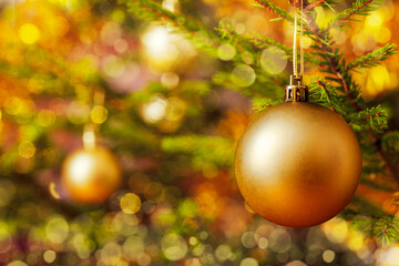 Christmas celebration holiday background - christmas-tree decoration bauble on decorated Christmas tree with defocused blurred lights bokeh and copyspalce