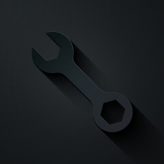 Paper cut Wrench spanner icon isolated on black background. Paper art style. Vector