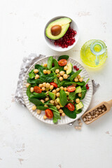 Overhead view of healthy food vegan avocado salad chick pea on light surface