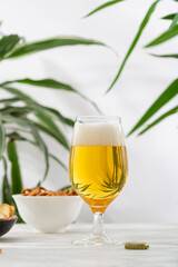 A glass light beer and snacks in bowl food and drink summer concept